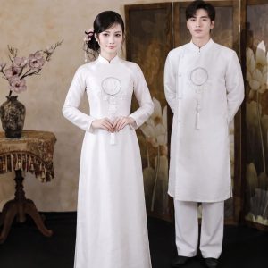 Cặp đôi mặc áo dài trắng truyền thống chụp ảnh tại studio.